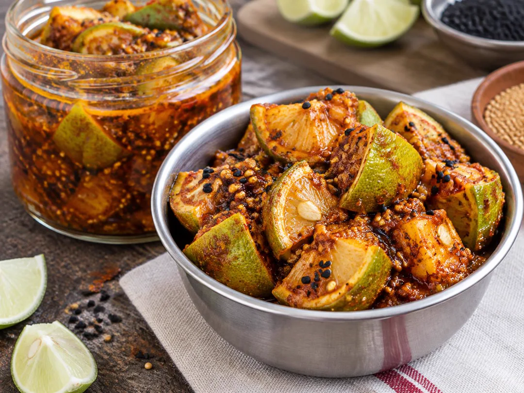 Instant Lime Pickle — Lime wedges with visible peel and seeds coated in red mustard-oil pickle spices