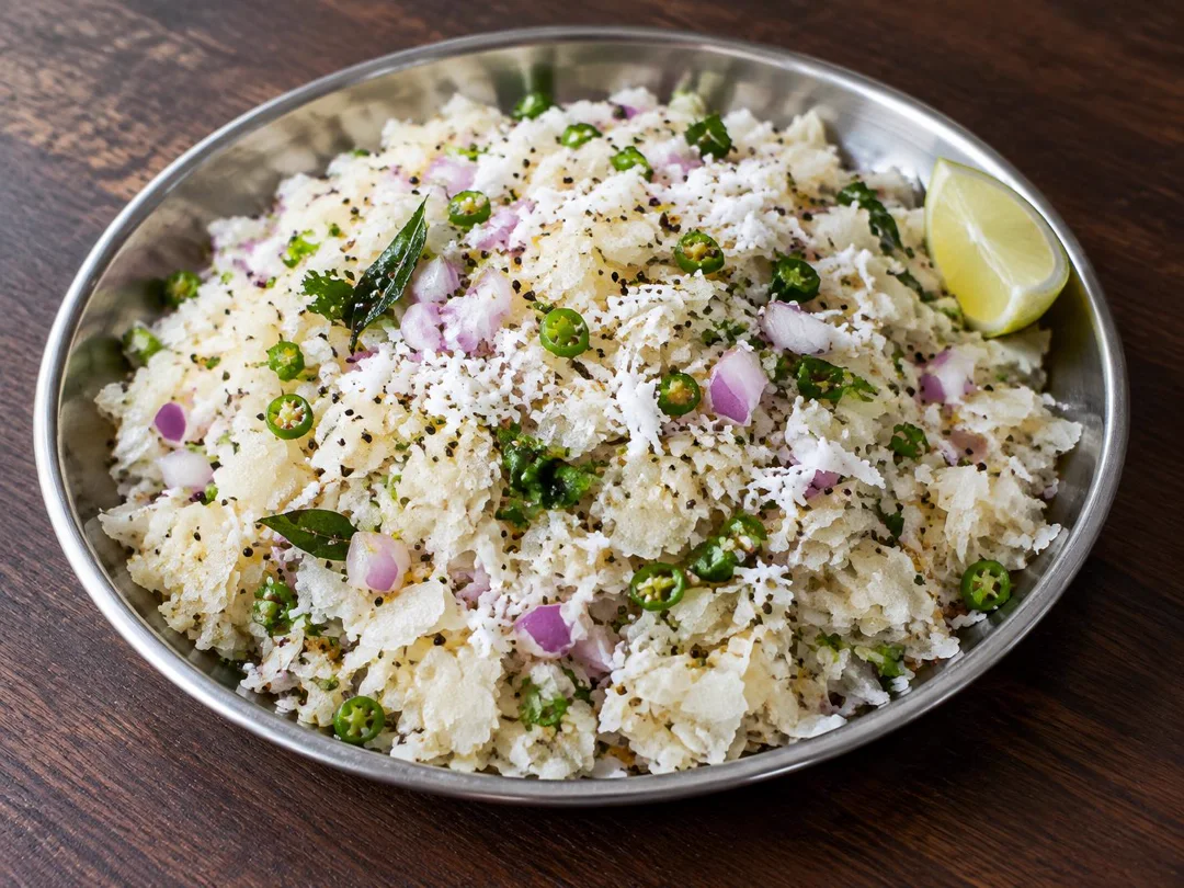 Dadpe Pohe — Lightly moistened thin Dadpe Pohe flakes with raw onion, coconut, green chilli and mustard tempering