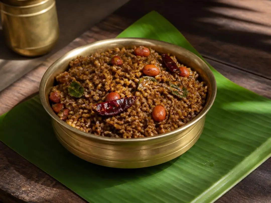 Puliyodarai — Dark tamarind rice puliyodarai with peanuts and curry leaves