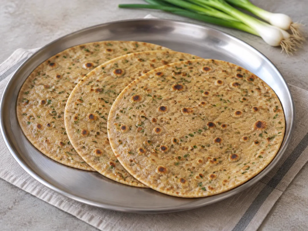 Spring Onion Paratha — Thin whole-wheat parathas with finely chopped spring onion incorporated into the dough and browned tawa spots
