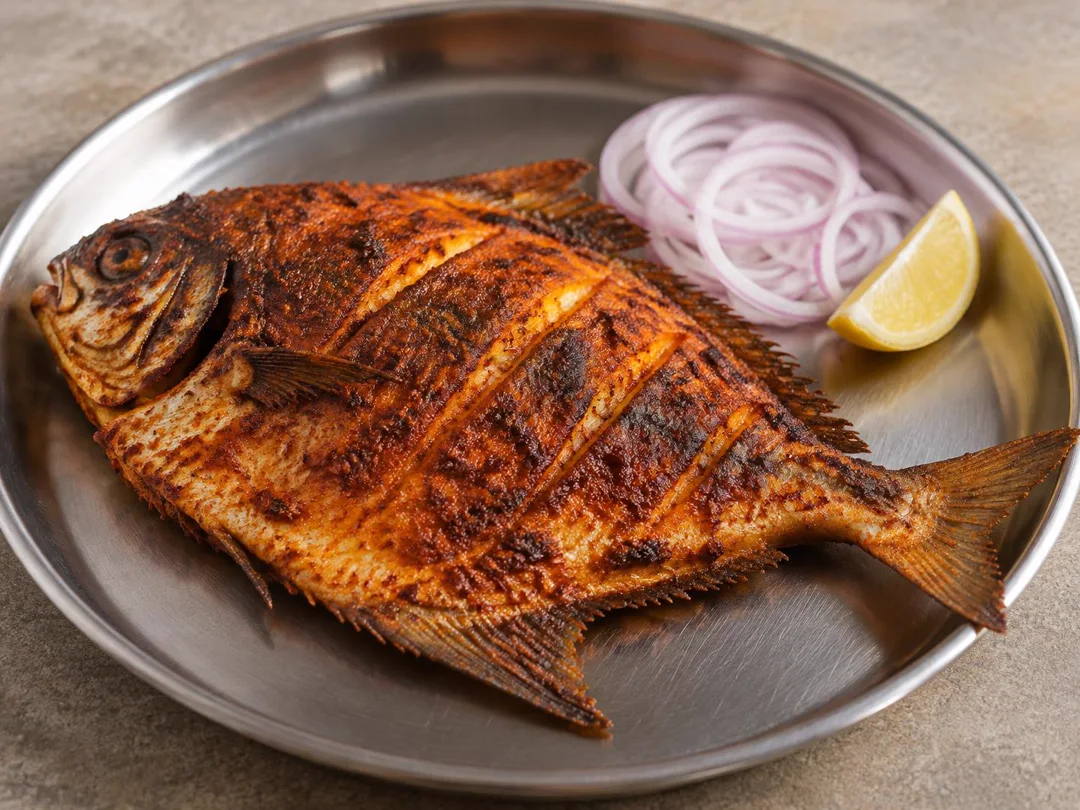 Pomfret Tawa Fry — Whole pomfret tawa-fried with a crisp red spice crust