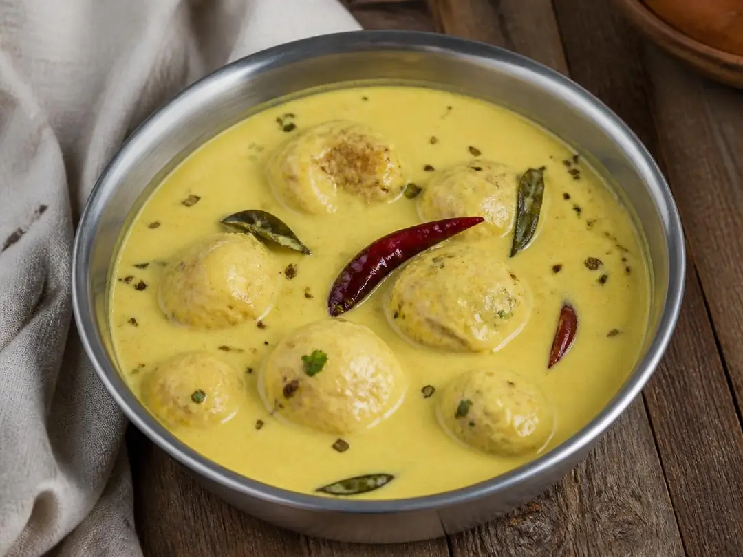 Punjabi Kadhi Pakora — Punjabi kadhi pakora with pakoras in yellow yogurt curry