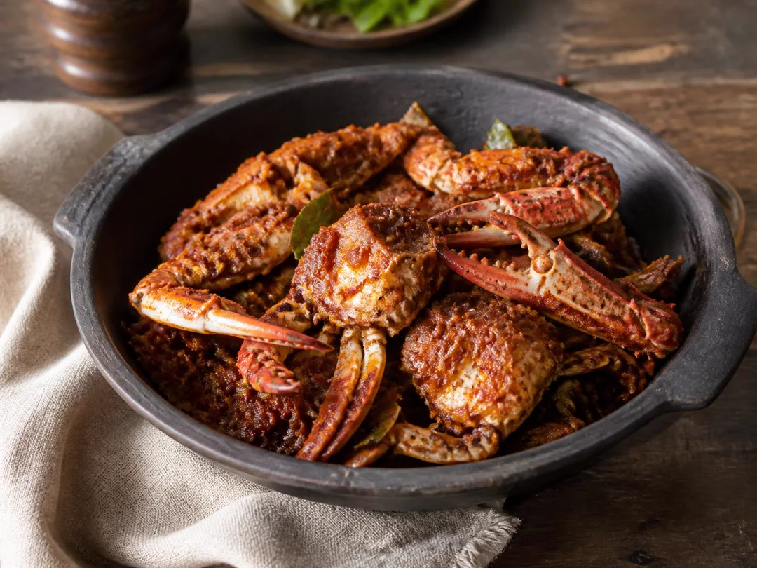 Crab Masala — Shell-on crab coated in dark roasted Chettinad masala with curry leaves